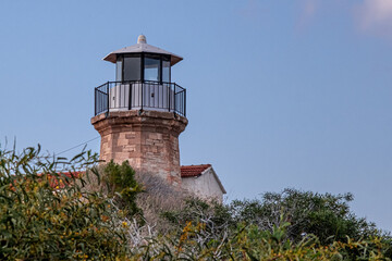 Fototapeta na wymiar The Lighthouse of Pervolia, a historic relic of the British rule, but still operational, located on Kiti Cape in Pervolia, near Larnaka, Cyprus 