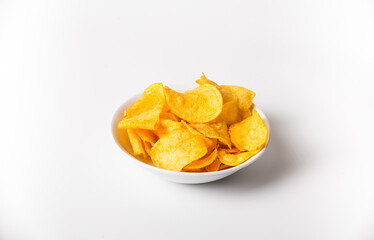 A bowl of chips is sitting on a white background. The chips are yellow and appear to be crunchy