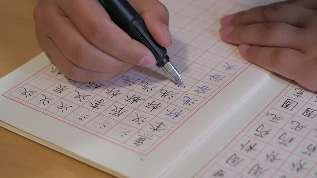 An Asian child is writing Chinese characters