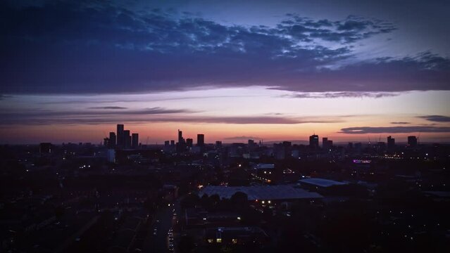 Aerial drone footage of the cityscape at sunset