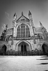 Vertical grayscale of the Winchester Cathedral in England with an empty entrance