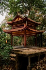 Vertical shot of the Tu Hieu Temple in a forest, Hue, Vietnam,