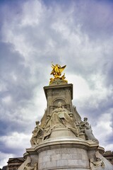 Fototapeta na wymiar Low angle shot of Queen Victoria Memorial.Golden monument winged statue angel near Buckingham Palace
