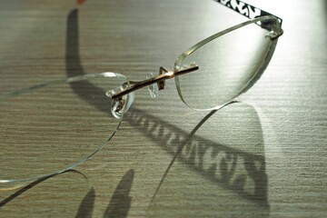 Closeup shot of classy eyeglasses placed on a wooden surface