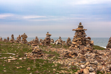 Holy Island of Lindisfarne, Northumberland, UK; a forest of tourist-laid stone cairns on Castle Point, in conflict with the Leave No Trace ethic