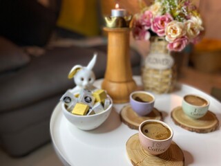 Nicely decorated table with coffee cups and chocolates