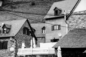 Black and white shot of tailed roofs of houses in a town, cool for background