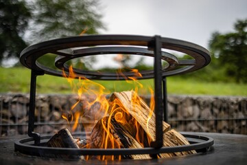 Closeup shot of the grill with open fire on a blurred background