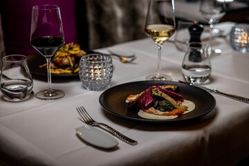 Dish with vegetables on a black plate at a restaurant