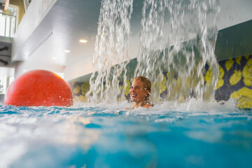 Young happy girl relaxing in the Rakvere spa pool.