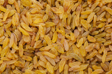 Raisins Background. Yellow Sultanas. Golden Dried Seedless Grapes Top View. - 784358565
