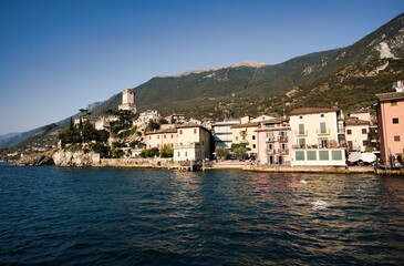 Fototapeta premium Landscape of Lake Garda surrounded by buildings and hills in Riva de Garda, Italy