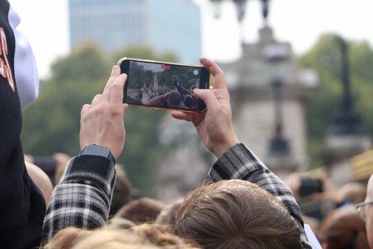View of people taking photos and videos of different attractions