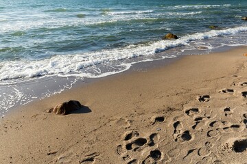 Close-up view of a sandy beach with the Baltic sea waves on a sunny day, Rerik Germany