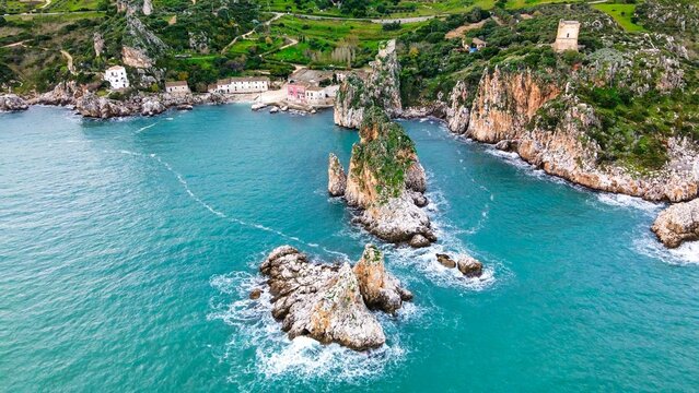 Aerial view of rocks over the sea at Faraglioni of Scopello in Sicily, Italy