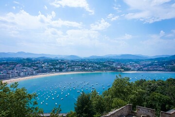 Scenic shot from the mount Urgull to the amazing cityscape of San Sebastian under blue cloudy sky