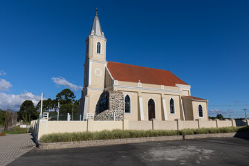 Scenic view of a catholic church against a cloudless blue sky - obrazy, fototapety, plakaty