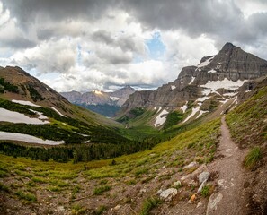 Trekking trail and rugged mountains in the background, in Glacier National Park in northern Montana