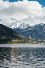 Beautiful Landscape Scenery View of snowy Hills Mountain by a lake on a Cloudy Day, vertical shot