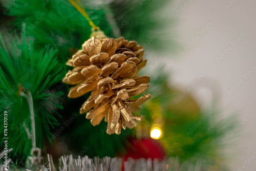 Wall mural closeup shot of a christmas tree golden pine decoration