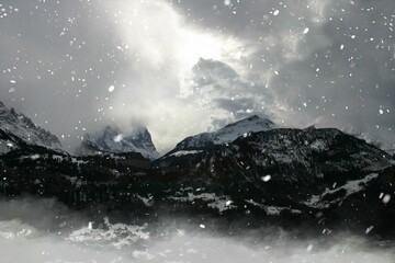 Mountain range in Switzerland's alps with strong clouds and bright light at midday - obrazy, fototapety, plakaty