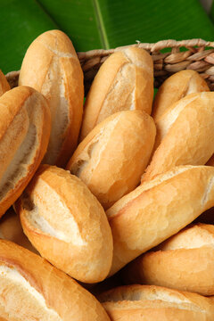 Bread rolls in basket on palm leaf