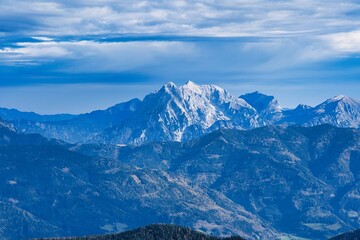 Breathtaking view of snowy mountains against a blue cloudy sky on a beautiful day