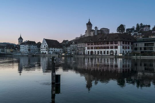 Time lapse of Schaffhausen Munot at sunset till night reflecting on the river in Switzerland
