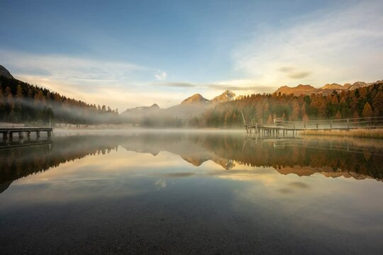 Time lapse scene landscape of sunrise of Lake of Staz with reflecting trees in Switzerland