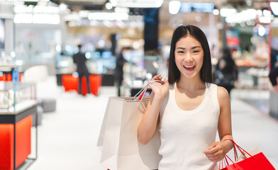Happy smile portrait young beautiful face asian woman shopping bags at indoors