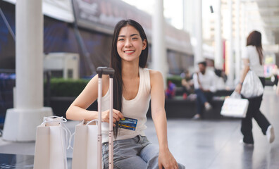 Portrait young beautiful face asian woman holding credit card and shopping bags city lifestyles