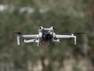 New drone with omnidirectional obstacle sensor, 4K camera and accessories parked horizontally with the camera tilted to the ground.