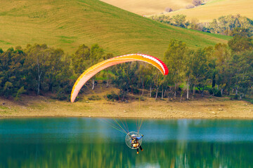 Paraglider flying over spanish nature landscape in Andalucia.