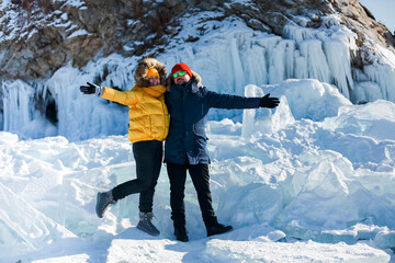 Happy couple on the frozen winter Lake Baikal