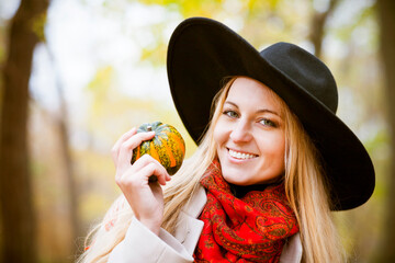 Fashionable blond woman at beautiful autumn alley