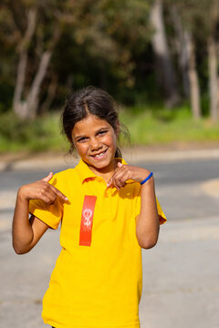 schoolgirl proudly showing off her second place ribbon