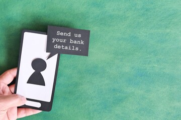 Send credit card bank details text message smishing scam concept. Hand holding mobile phone with message from unknown sender.