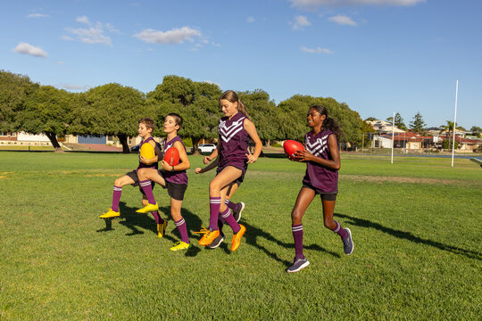 children in football team training on playing field
