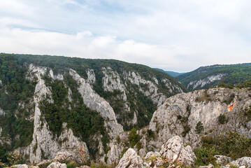 Zadielska tiesnava gorge with steep rocky slopes above from Zadielska planina in Slovensky kras national park in Slovakia - obrazy, fototapety, plakaty
