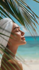 Elegant Woman Smiling with Closed Eyes under Palm Leaves, White Towel Wrapped around Head
