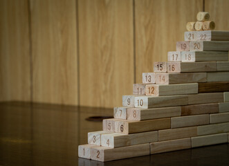 Numbers ascending on many wooden blocks. Concept of staircase and progress step by step with the reward ahead. 