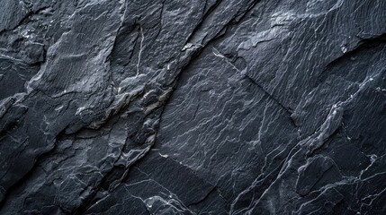 Dark gray background of natural slate. Texture black stone close up.