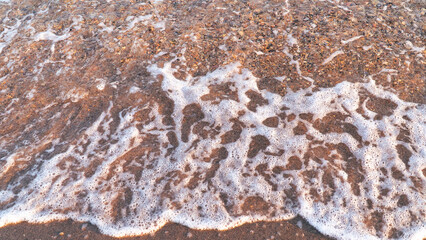 Sandy beach background with sea waves.