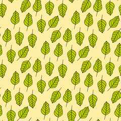 Seamless pattern in wondrous bright green leaves on yellow background. Vector image.