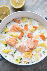 Middle close-up of lohikeitto or finnish traditional soup with salmon, vertical shot, selective focus