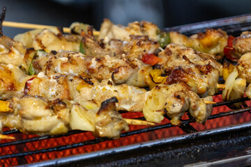 Grilled chicken kebab on a bamboo skewer.