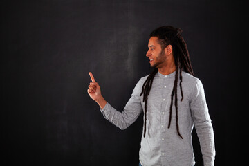 Rastafari young man next to a chalkboard