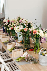 Obraz na płótnie Canvas Floral arrangement workspace with fresh cut flowers.