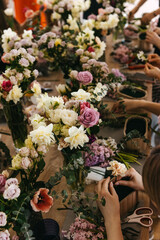 A floral arrangement workshop with participants creating bouquets.