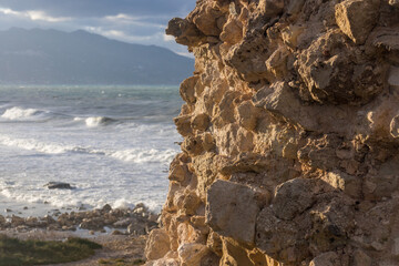 Windy day at the beach. Big waves. view from a rocky spot above tha beach. Mountains in the...